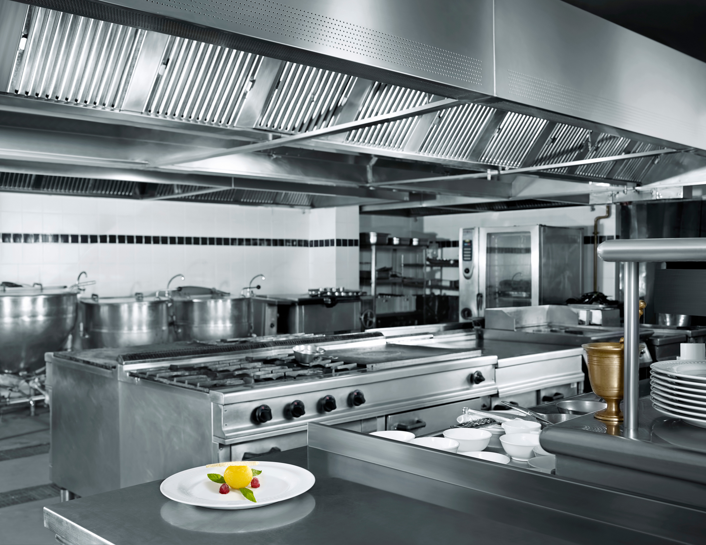 a black and white photo of a commercial kitchen